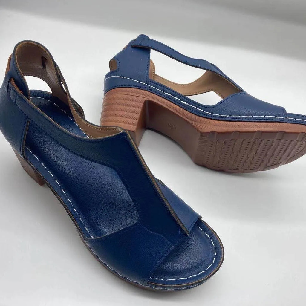 Women's white peep toe wedge sandals with a buckle strap on a slingback heel.