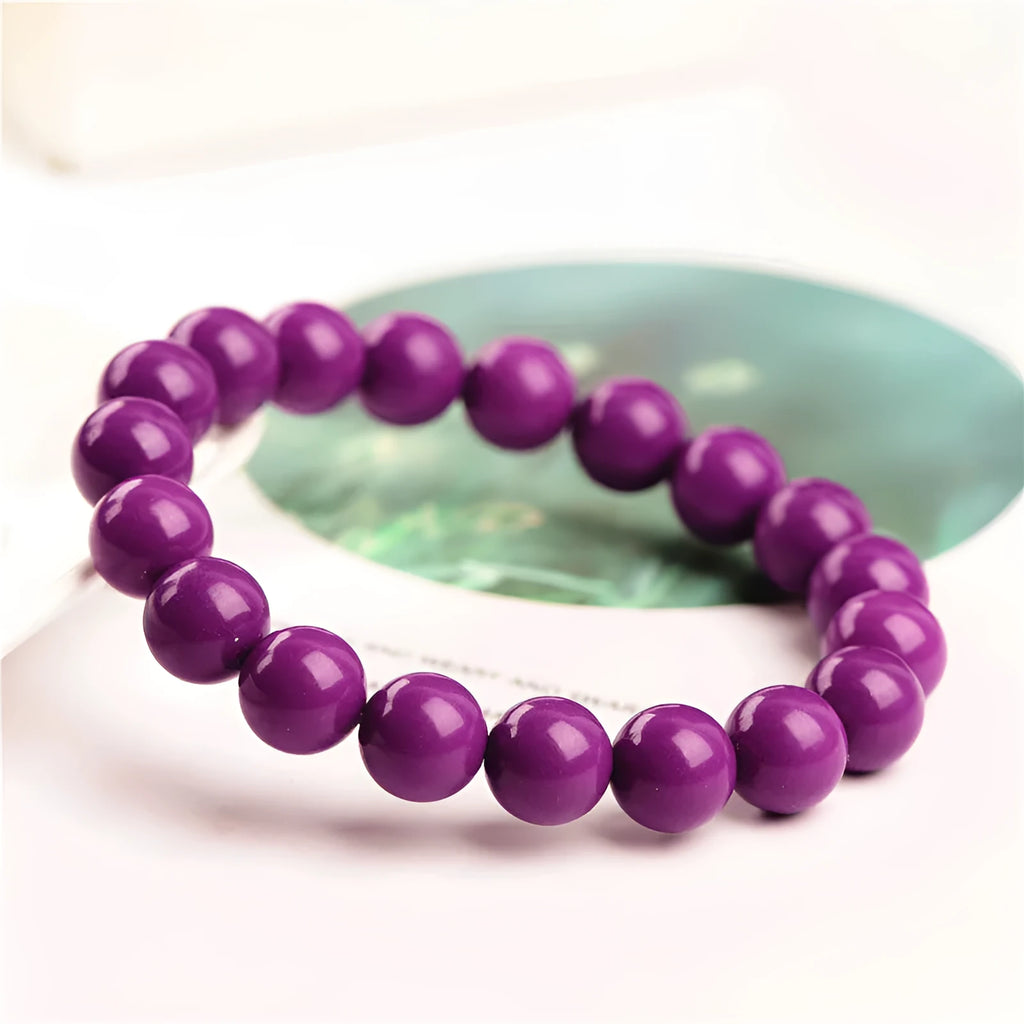 Single-strand Jiuya crystal bracelet in translucent purple mica with polished 8mm beads.