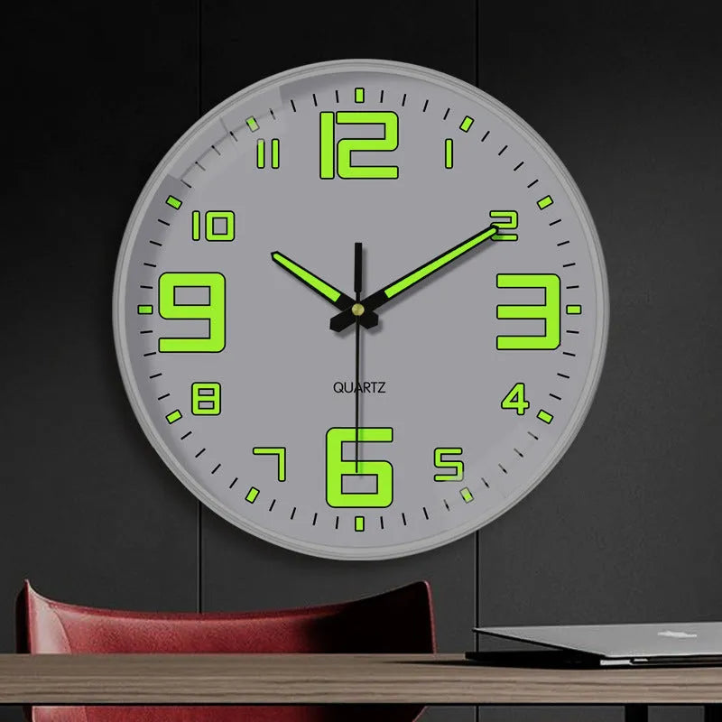 Modern 8 inch circular wall clock with luminous numerals on a white wall