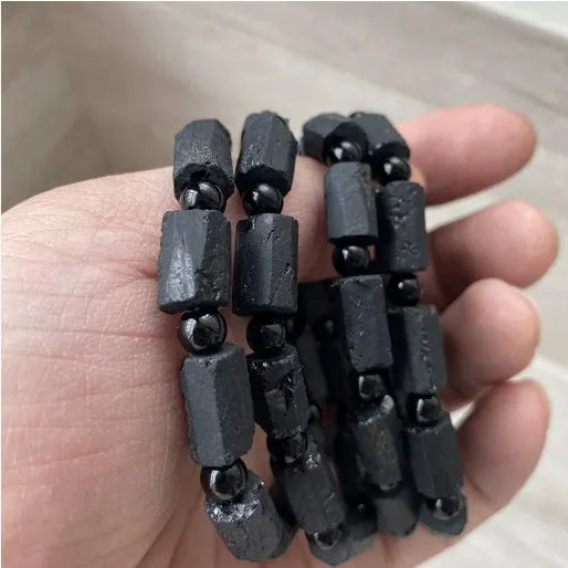 Natural black tourmaline rough stone bracelet with polished beads on wrist