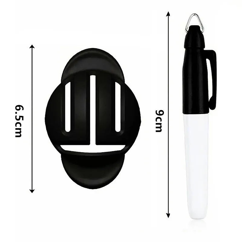 Close-up of a white golf ball with a black etched line next to a plastic golf scriber alignment tool with multiple tips.