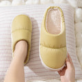 Pair of down cotton slippers with artificial leather upper and thick rubber sole, shown in available colours.