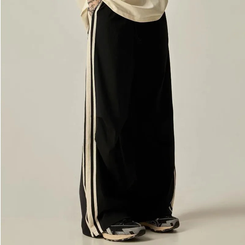 Black high-waist wide-leg climbing trousers for men laid flat, showing straight-leg style.
