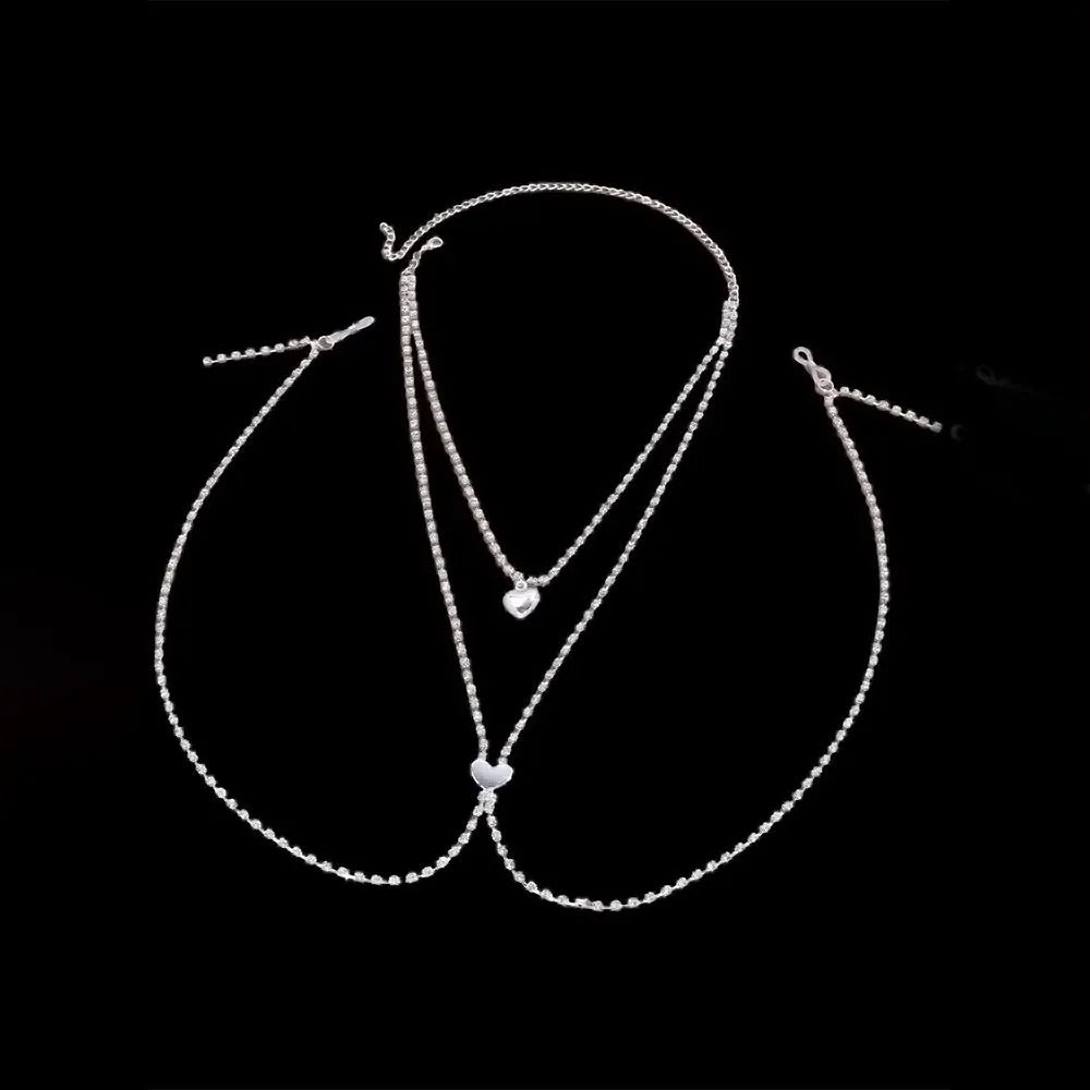 Gold or silver coloured heart-shaped body chain for women with rhinestone detailing.