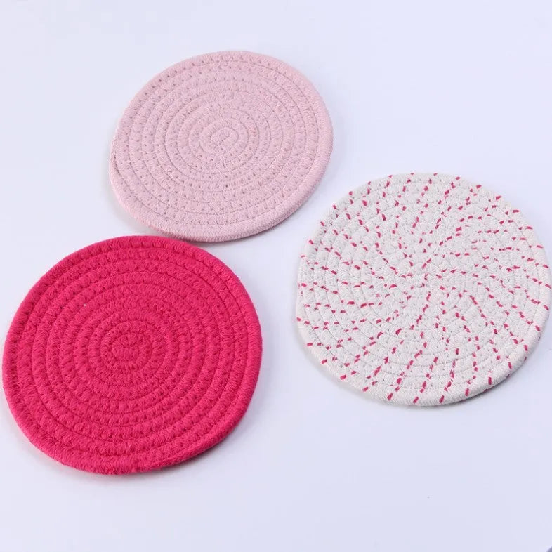Three round cotton cord coasters in 18cm diameter showing grey, pink, purple and blue colour options