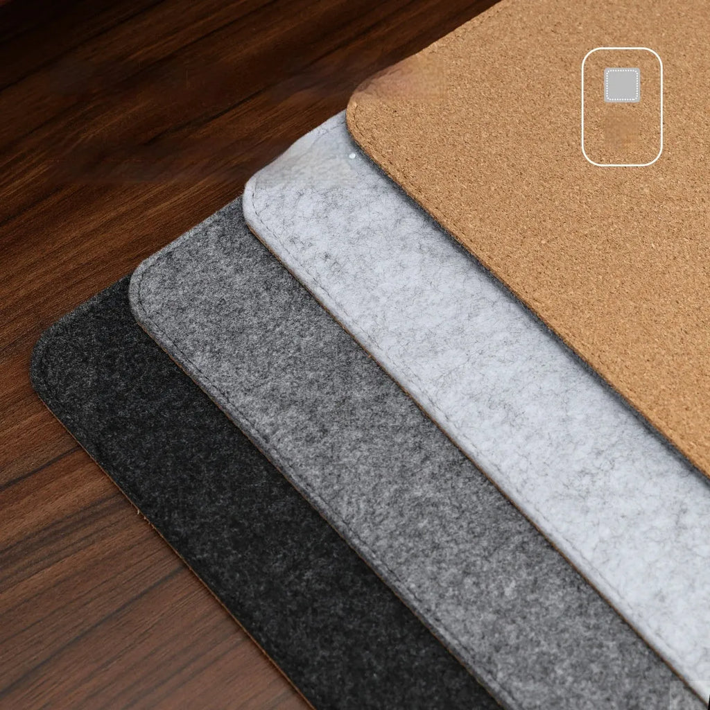Oversized felt cork desk mat in black and grey pattern on a wooden desk