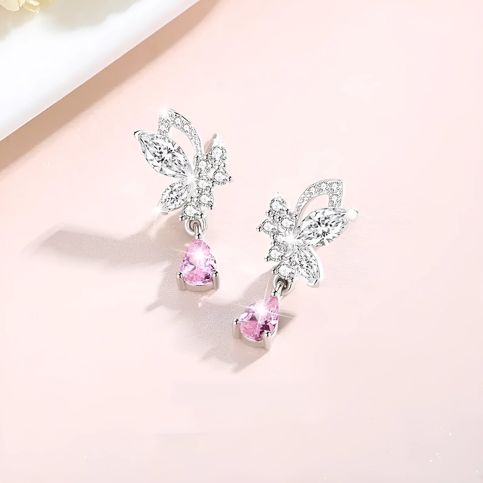 Silver stud earrings with butterfly shape and crystal accents in colour E0141