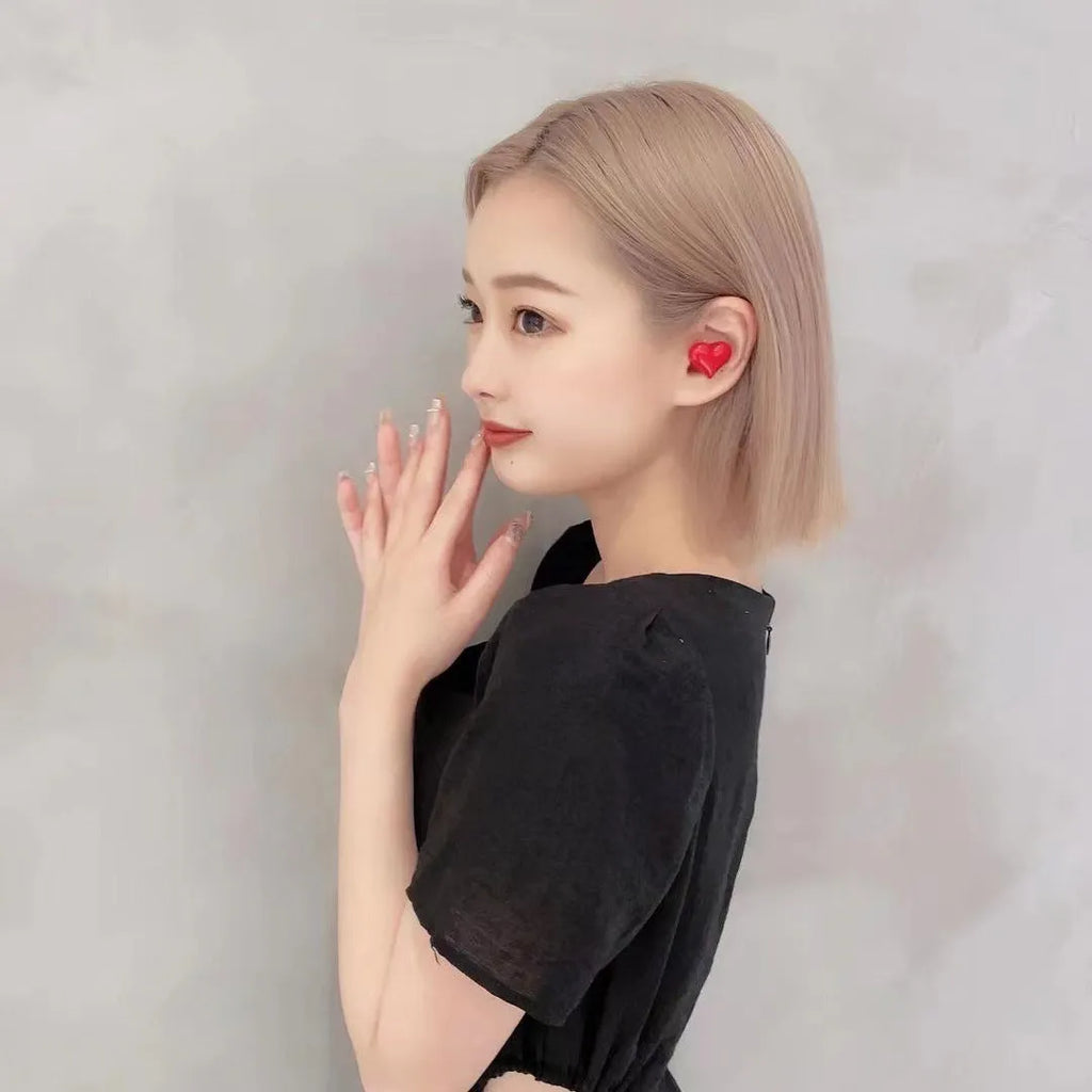 Heart-shaped wireless Bluetooth in-ear headphones in girl pink with charging cable