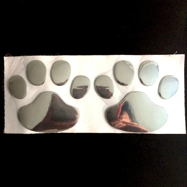 PVC car sticker with hand-shaped brush dog footprints design on a car bumper.