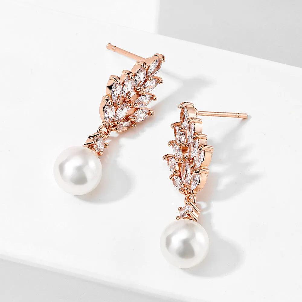 Gold plated geometric earrings with micro inlaid zircon stones in a floral design.