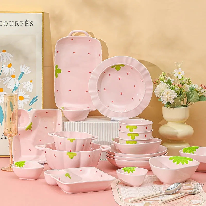 Strawberry-themed porcelain dinnerware set with plates, flower bowls, and microwave-safe spoons