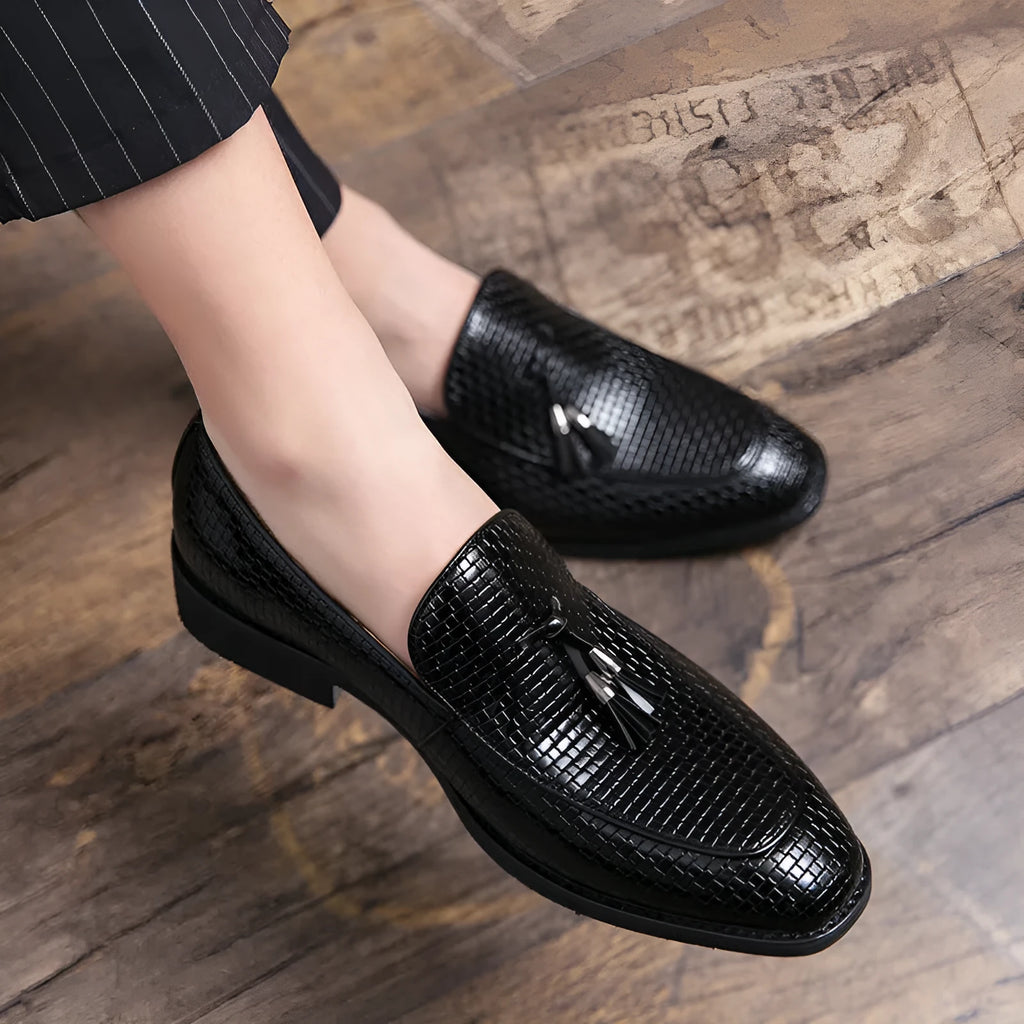 Men's black pointed toe slip on shoes with a tassel detail, made from artificial PU material for business wear.