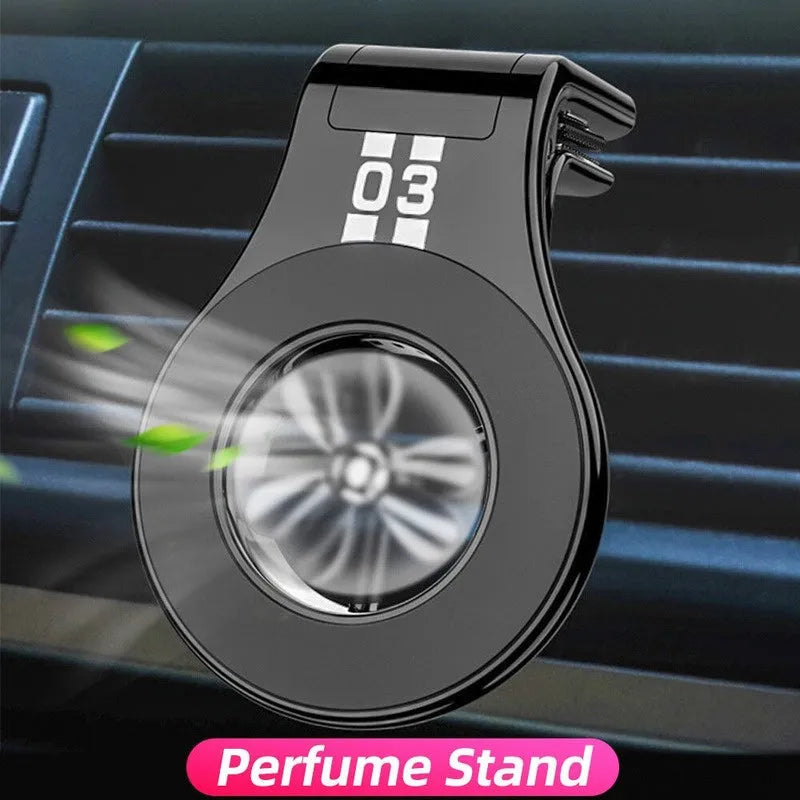 Black magnetic car phone holder clipped to a car air vent, showing a smartphone attached and the 360-degree rotating bracket.