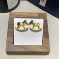 Diamond studded rocking horse earrings in gold and silvery metal finish for women