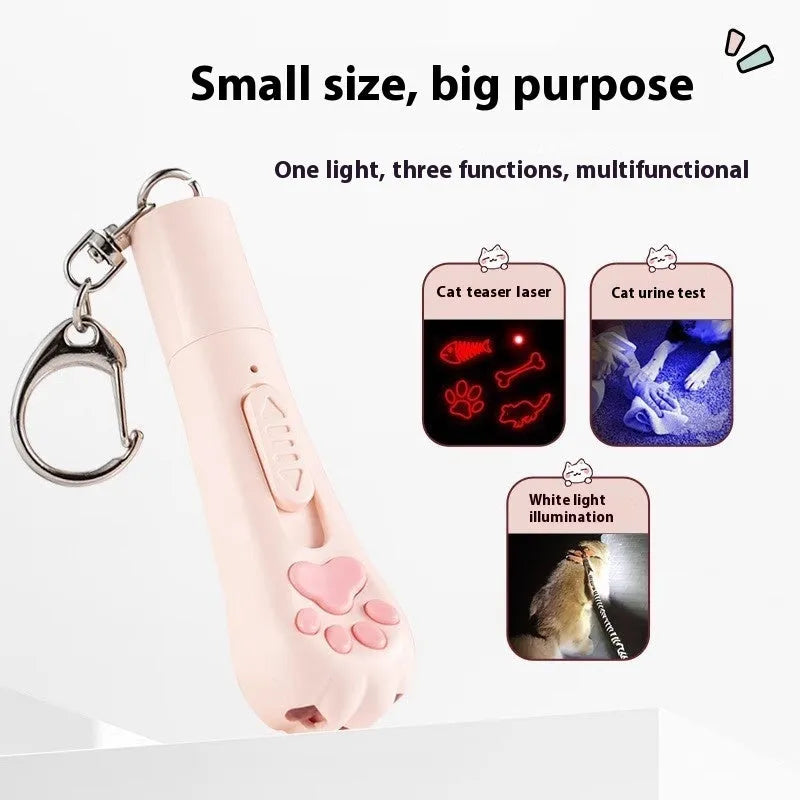 Pink automatic cat teaser toy with a wand attachment on a hardwood floor, showing compact circular base.