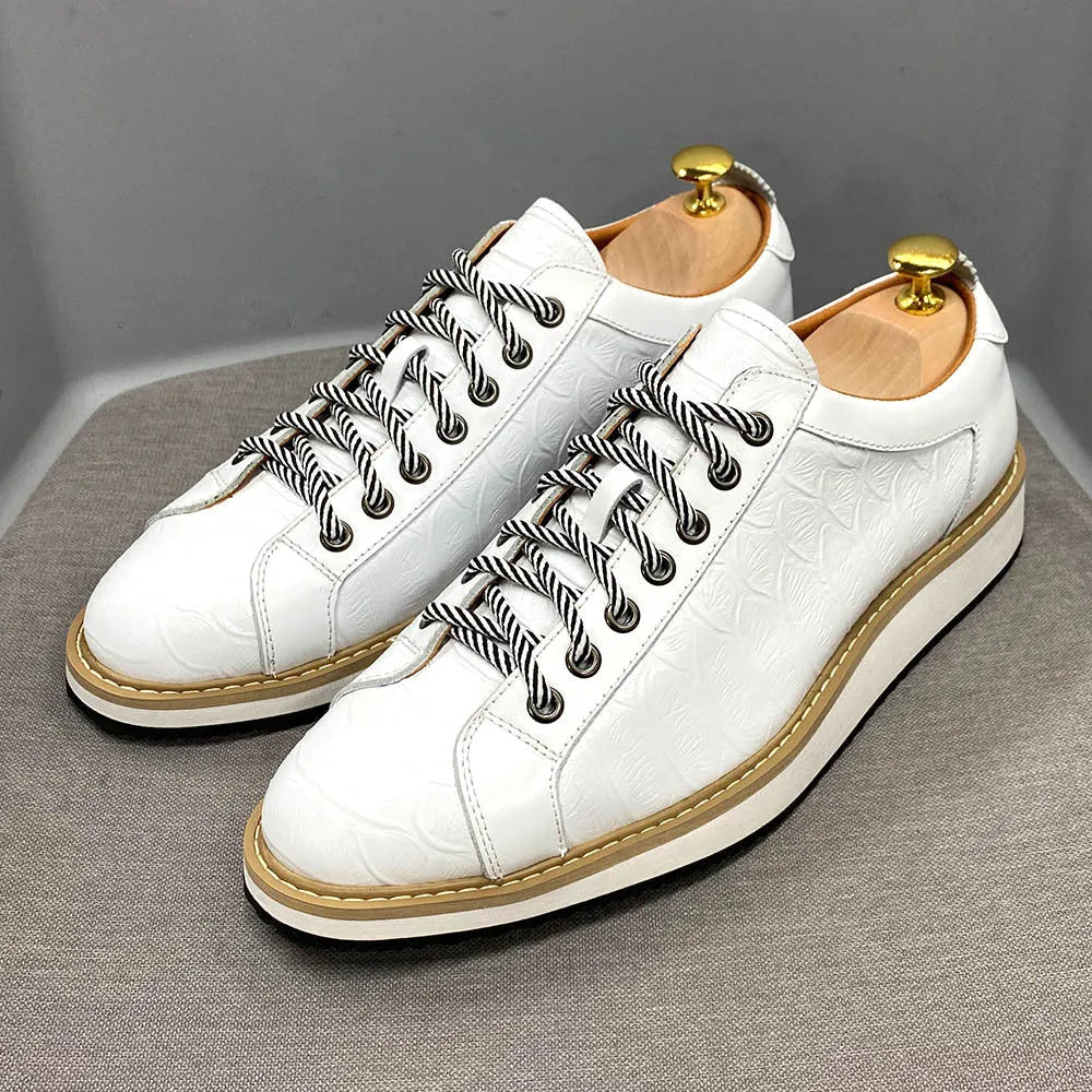 Men's low-top handmade shoes with embossed pattern on upper, shown in black with front tie laces.