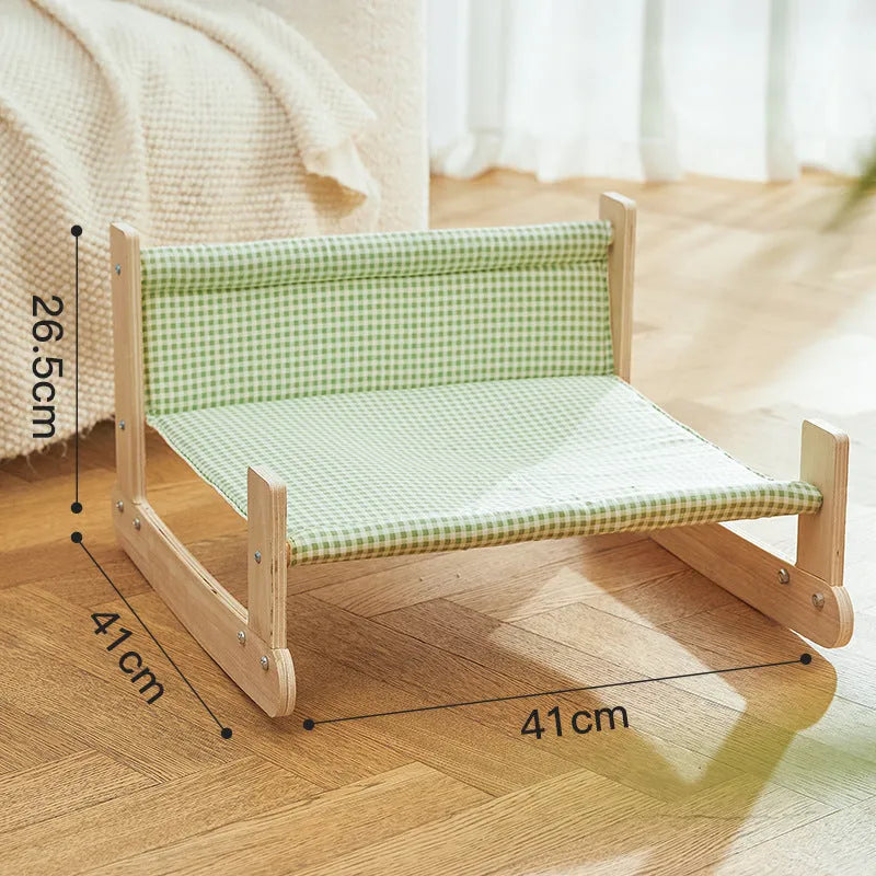 Elevated wooden cat bed with blue cloth hammock in beach chair style