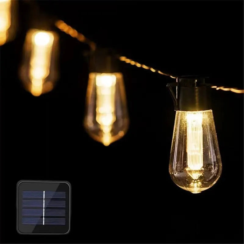 Retro long bulb outdoor string lights in a garden setting, showing solar panel, battery box, and USB power options.
