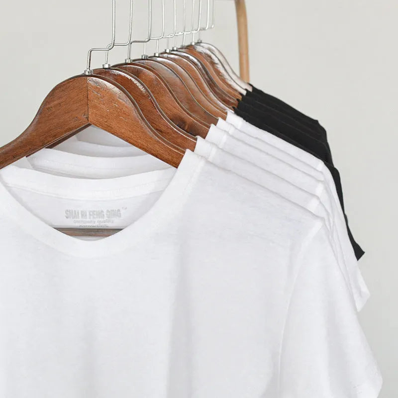 Men's solid colour cotton T-shirt on a hanger, showing round neck and short sleeve design.