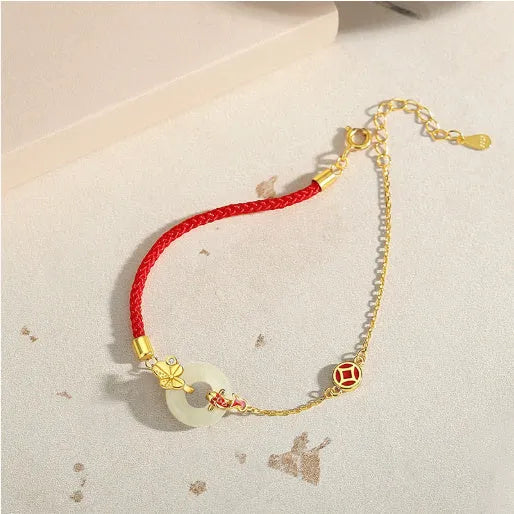 Gold koi peace buckle bracelet made from 925 silver with red rope closure
