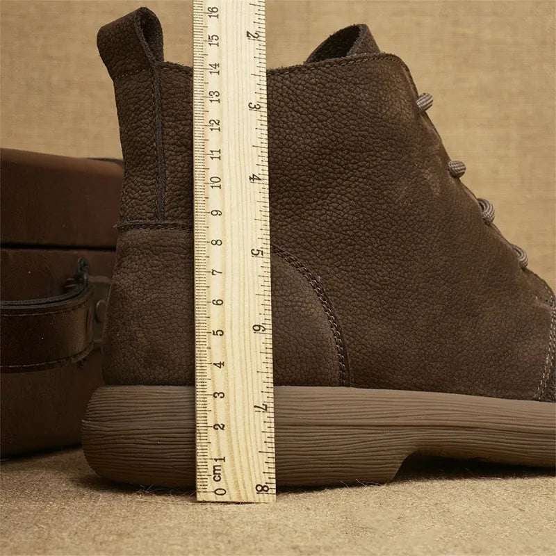 Men's grey genuine leather Martin boots with lace-up front and wedge heel on a textured background.