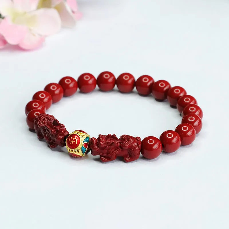 Purple gold sand cinnabar bracelet with carved double Pixiu design, 8mm beads.