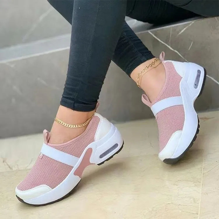 Women's lightweight mesh flat sneakers in multiple colours with a round toe and rubber sole.