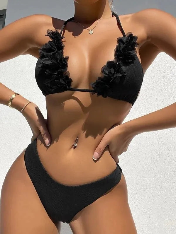 Black polyester swimwear two-piece set with a gathered design, showing the top and matching shorts.