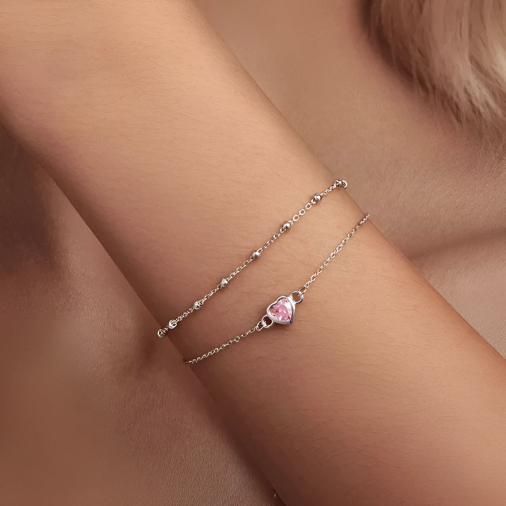 Women's sweet style sterling silver bracelet with small heart pendant on an adjustable chain.