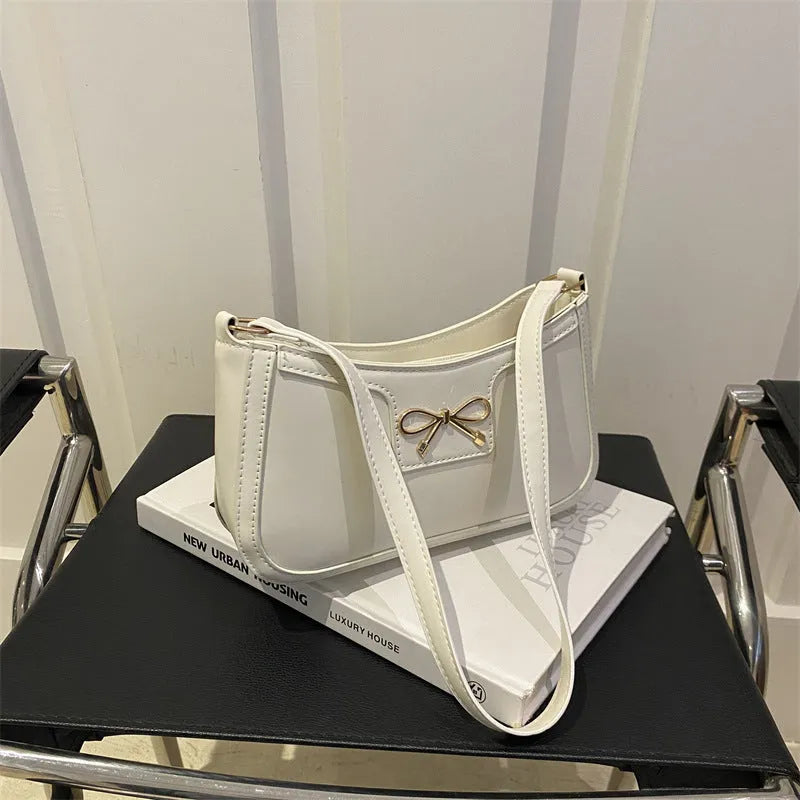 Western style PU leather shoulder bag in horizontal square shape with bow decoration, shown in rose pink colour.
