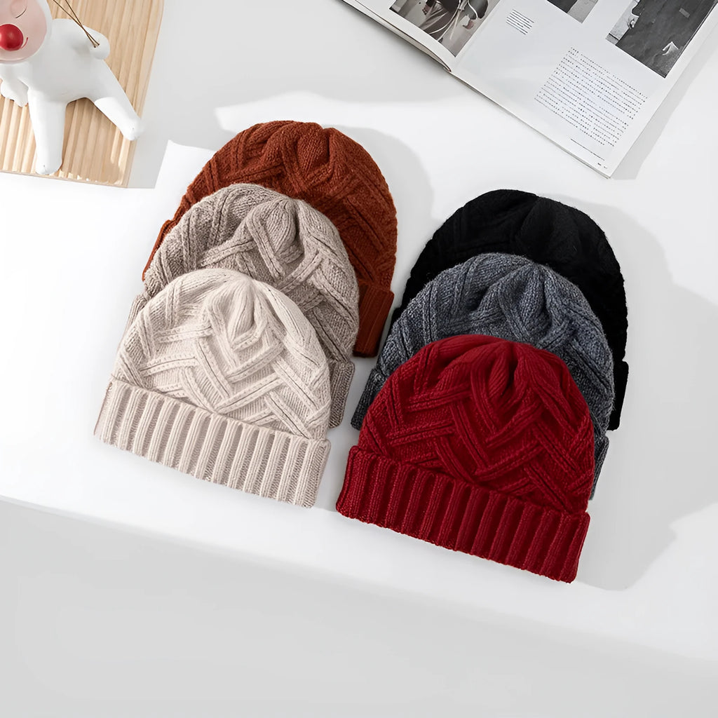 A woman's wool knitted winter hat in a dome crown style, shown in ankela red colour.