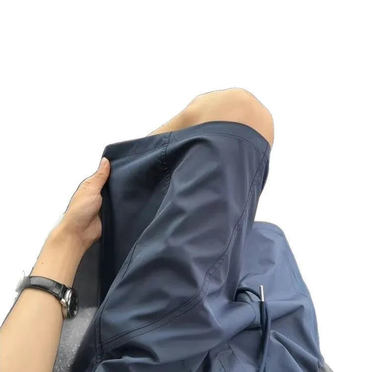 Men's quick-drying polyester sports shorts in creamy-white with elastic waistband