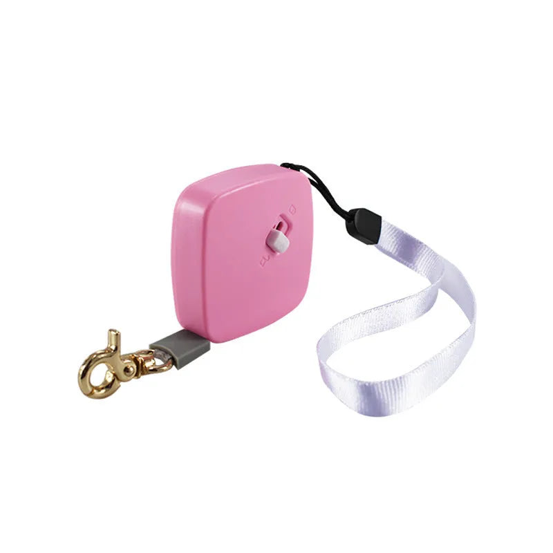 Retractable dog lead with 2m nylon tape, lock button, and non-slip handle in white, pink, or blue.