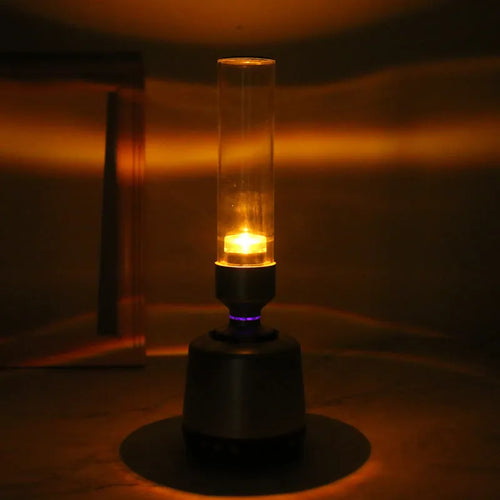 White silver candlelight Bluetooth speaker and LED atmosphere light on a table.