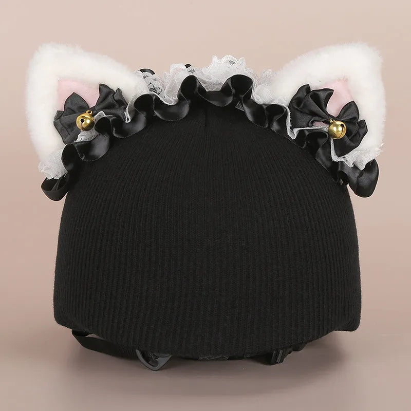 Colourful plush cartoon hat decoration sitting on top of a ski helmet