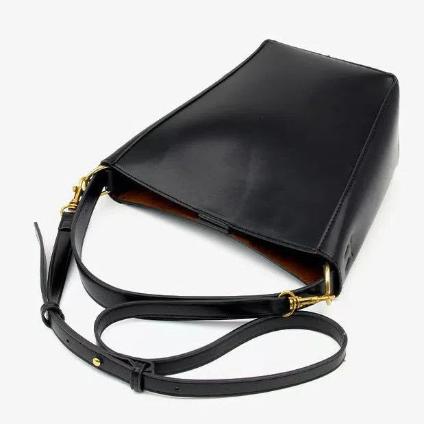 Urban minimalist bucket-style crossbody shoulder bag in PU with three-dimensional outer pocket, black colour option, flat lay view