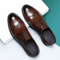 Men's black and brown brogue business shoes with a PU leather upper on a white background.