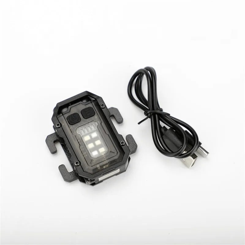 Portable tactical torch with USB cable mounted on a backpack strap.