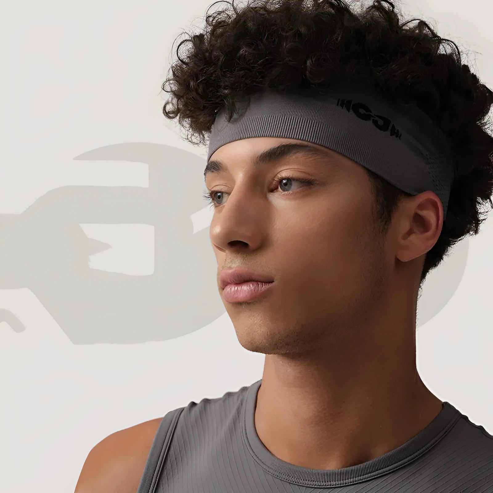 Seamless knitted exercise hair band in black, grey, or blue, made from nylon and spandex blend.