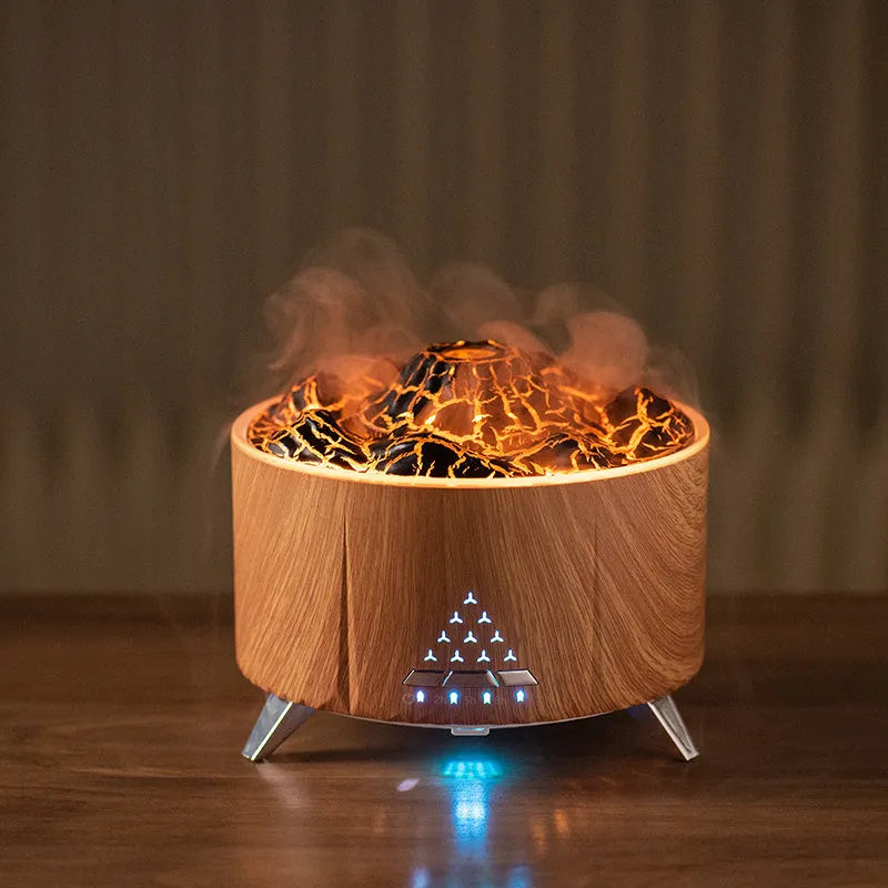White flame aroma diffuser with Bluetooth speaker and remote control on a table