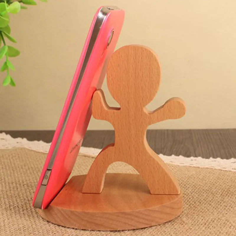 Solid beech wood phone holder with resin puppy decoration and a pound coin in the integrated slot.