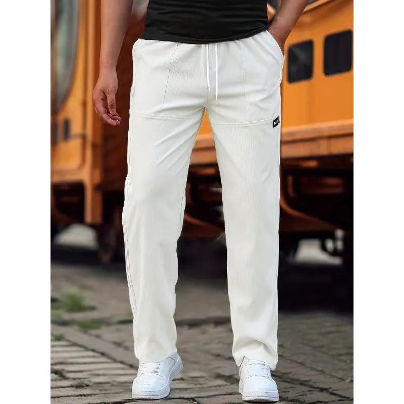 Men's light grey polyester casual trousers for spring and autumn wear.
