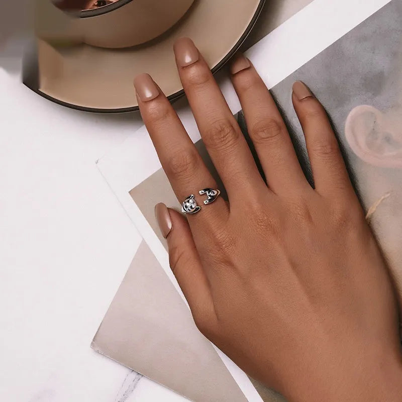 Adjustable sterling silver panda ring with white gold plating on an open band.