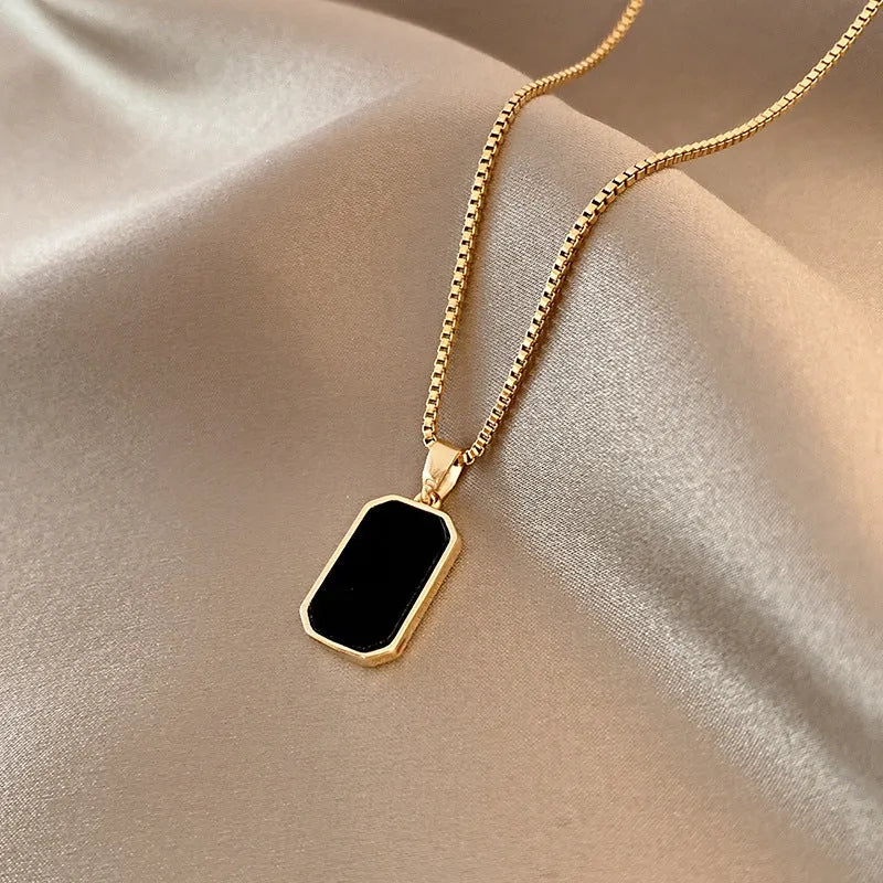 Rectangular pendant necklace in 18K gold plated titanium steel with box chain, black geometric design, 41-50cm.