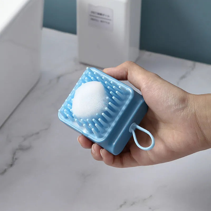 Pet bath brush with soft TPR combs for dog and cat grooming, available in blue, pink, white, and yellow.