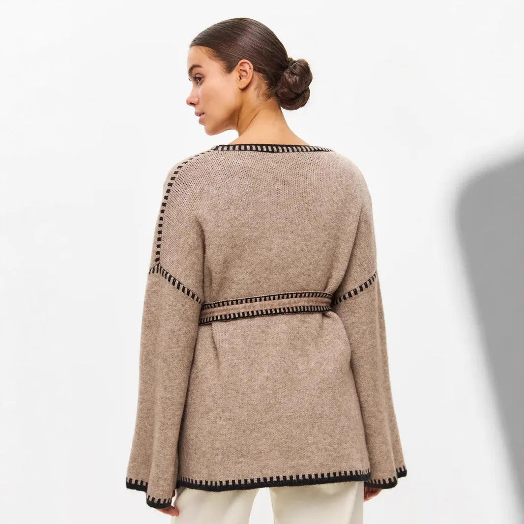 Loose black lace-up knitted cardigan on a hanger