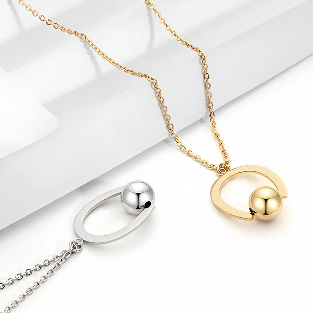 Gold and silver stainless steel necklace with geometric pendant on a cross chain, adjustable length.