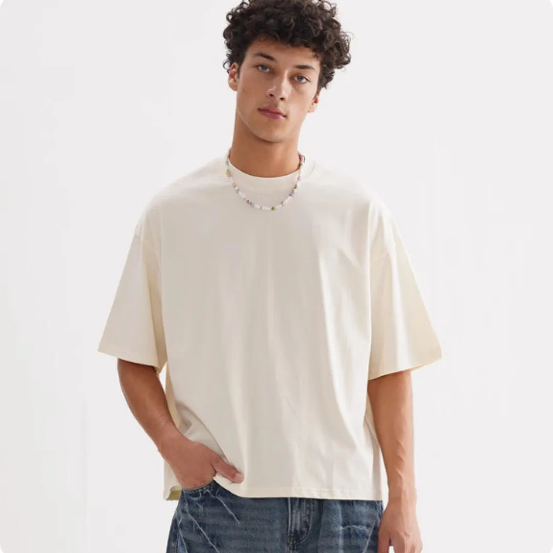 American style loose fit pure cotton T-shirt shown in apricot colour on a model.