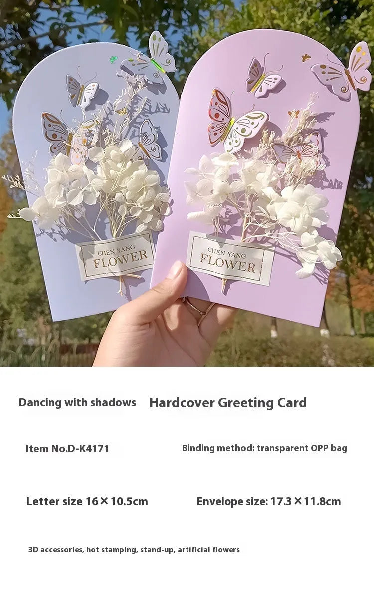 Handmade 3D butterfly-shaped birthday card with artificial flowers, shown with its matching envelope.