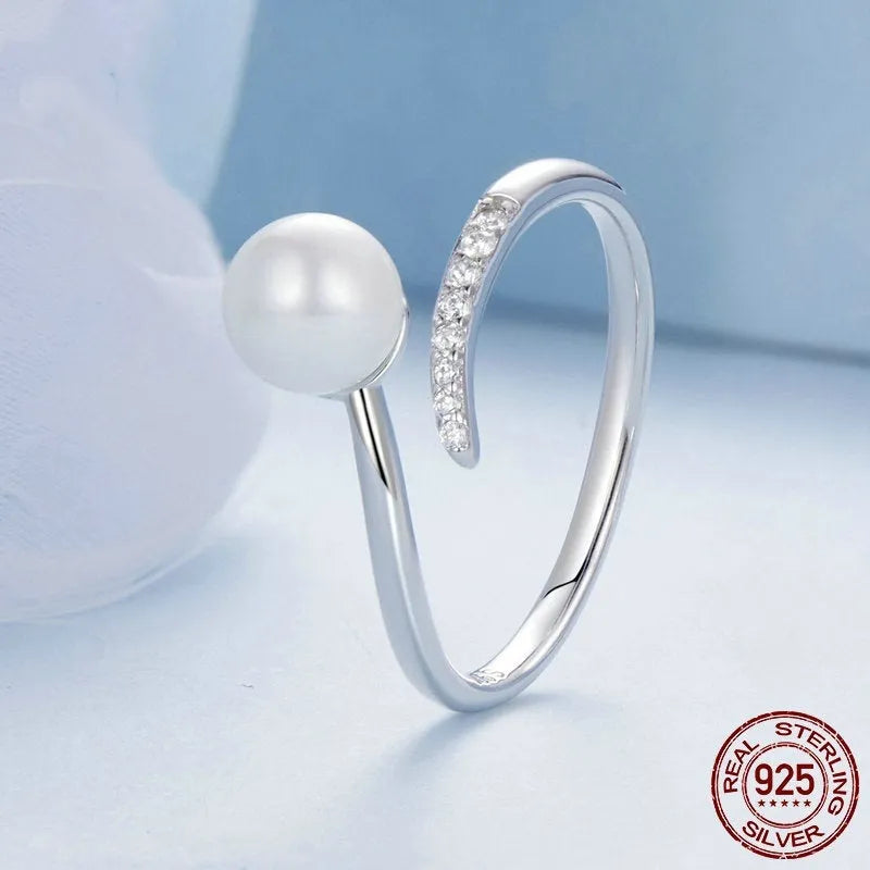 Sterling silver adjustable ring with shell pearl centrepiece on grey background